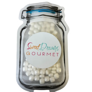 a jar filled with white candies on top of a white table