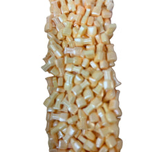 a pile of corn sitting on top of a white table