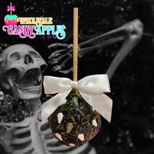 A candy apple with a white ribbon and a spooky skeleton in the background.