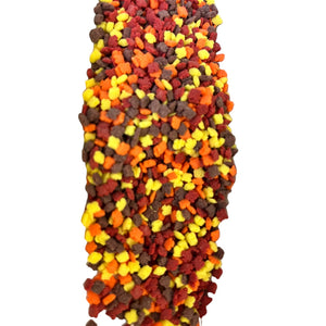 a large pile of candy corn on a white background