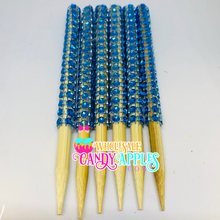 a group of blue and yellow toothpicks sitting on top of each other