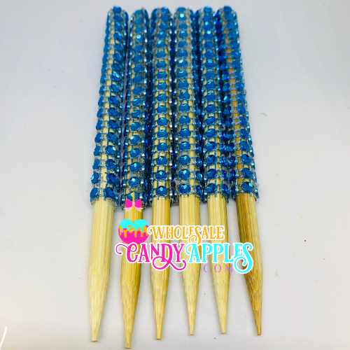 a group of blue and yellow toothpicks sitting on top of each other