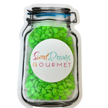 a jar filled with green candy beans