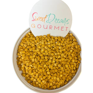 a bowl filled with yellow granola next to a sign that says sweet dreams go