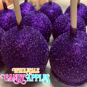 purple candy apples with wooden sticks sticking out of them