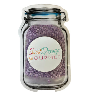 a jar filled with purple beans and a label that says sweet dreams gourmet