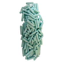 a pile of green pills on a white background