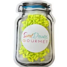 a jar filled with yellow and green candy