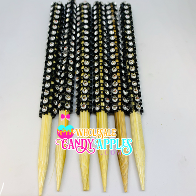 a bunch of black and white beads on wooden sticks