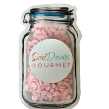 a jar filled with pink and white marshmallows