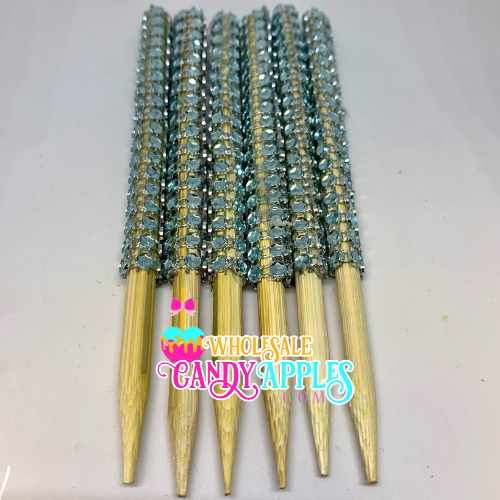 a bunch of gold and blue beads on a white surface