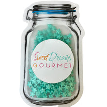 a jar filled with blue and green sprinkles