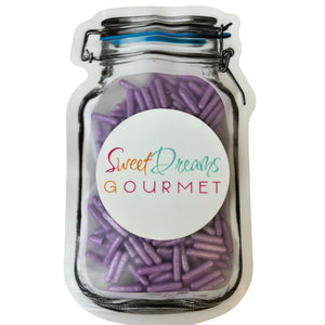 a jar filled with purple candy sticks