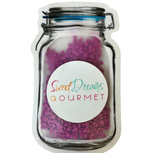 a jar filled with lots of purple beads