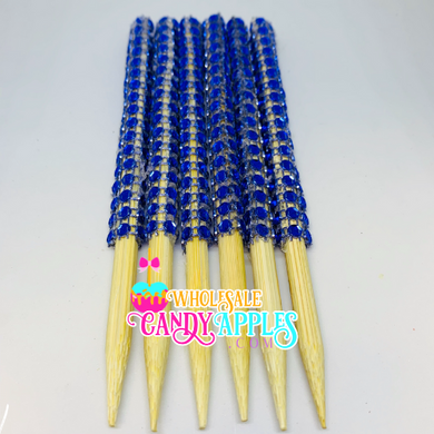 a group of blue and yellow toothpicks sitting on top of each other