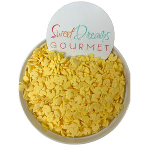 a bowl filled with yellow candies next to a sign