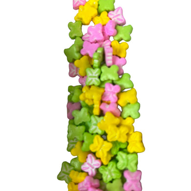 a tall tower of colorful candies on a white background