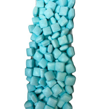 a large pile of blue marshmallows on a white background